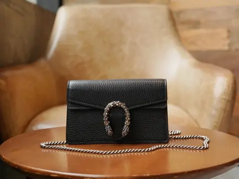 Black Leather Clutch with Silver Chain Strap and Decorative Ring Closure