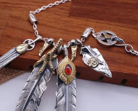 Silver and Gold Feather Charm Necklace with Red Gemstone