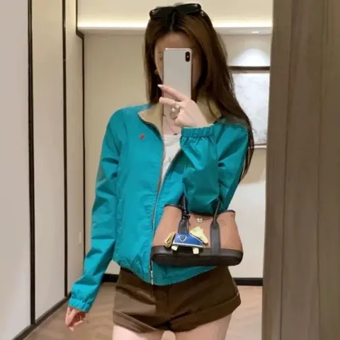 Teal Bomber Jacket with Brown Shorts and Crossbody Bag