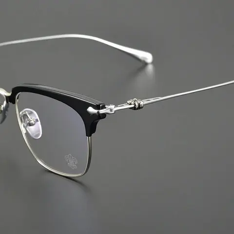 Black and Silver Half-Rim Eyeglasses with Fleur-de-Lis Logo