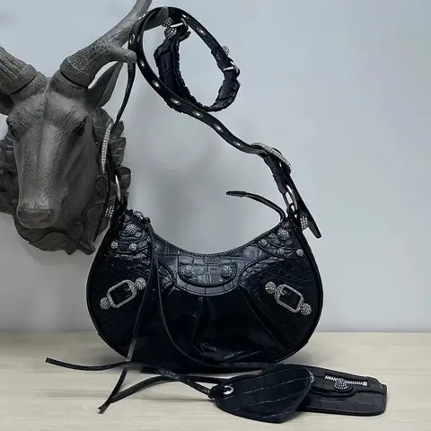 Moon-shaped studded crossbody bag with heart-shaped mirror