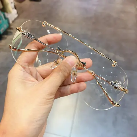 Gold Rimless Eyeglasses with Ornate Hinges